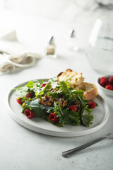 Healthy green salad with raspberry and walnut