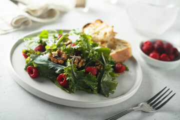 Healthy green salad with raspberry and walnut