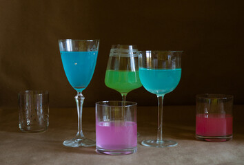 glasses with multicolored alcohol on the table