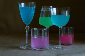 glasses with multicolored alcohol on the table