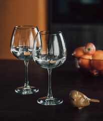 glasses in the kitchen, on the dining table. empty glassware on the background of the kitchen interior. beautiful highlights in glass goblets