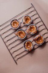 Freshly baked pumpkin pastry on minimalistic beige nude neutral background with copy space halloween concept with pentagraam