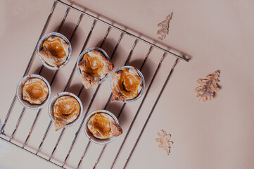 Freshly baked pumpkin pastry on minimalistic beige nude neutral background with copy space halloween concept with pentagraam