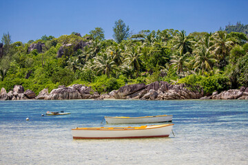 Boat on the shore of a tropical island. Pleasure boat moored on the shore of the resort. Beautiful tropical landscape of the Seychelles.