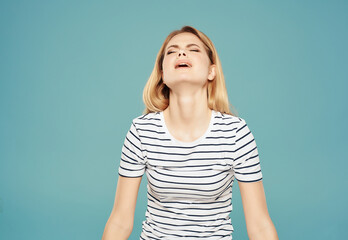 blonde girl in striped t-shirt fun glamor posing blue background