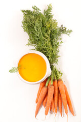 Obraz na płótnie Canvas bowl of carrot soup on white background