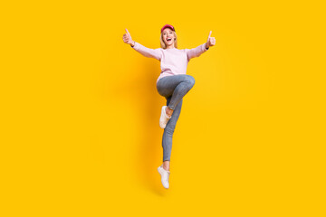 Fototapeta na wymiar Full body photo of young cheerful girl happy positive smile jump show thumb-up like fine ad isolated over yellow color background