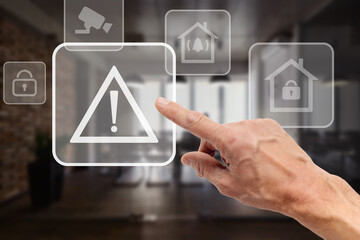 Male user touching button of smart home app virtual dashboard to control security system in office