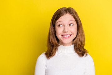 Photo of dreamy young curious little girl look empty space imagine isolated on yellow color background