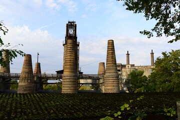 view of pipes and building of an old lime plant