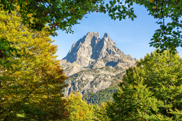 View of Pic du Midi d'Ossau through a autumnal beech trees frame. French Pyrenees climbing...