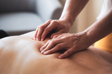 Fototapeta na wymiar Man having a back massage in massage salon
