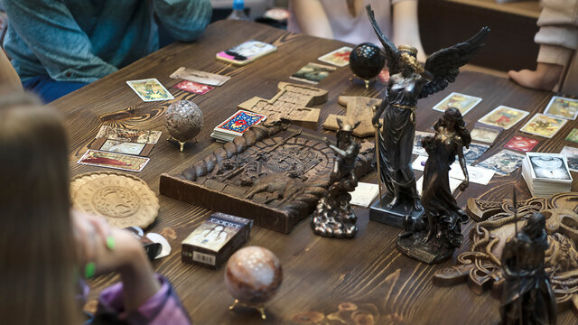 Tarot card reader arranges cards in a card spread. Fortune-telling concept