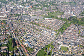 Aerial drone photo of the beautiful historical town of Harrogate, North Yorkshire in the UK showing the residential housing estates and rows of houses from above in the summer time - obrazy, fototapety, plakaty