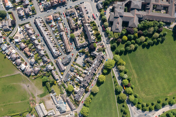 Top down aerial drone photo of the beautiful historical town of Harrogate, North Yorkshire in the UK showing the residential housing estates and rows of houses from above in the summer time - obrazy, fototapety, plakaty