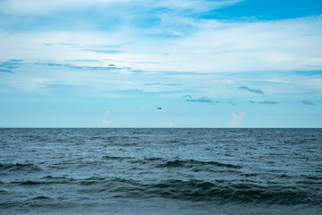 Black Hawk helicopter flys low over costal waters