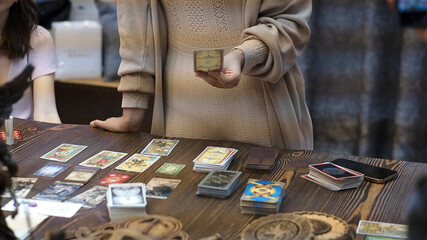 Tarot card reader arranges cards in a card spread. Fortune-telling concept - obrazy, fototapety, plakaty