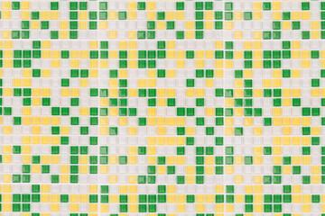 A tile background with white, yellow, and green