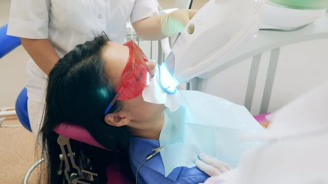 Oral hygiene procedure is being carried out on a female patient