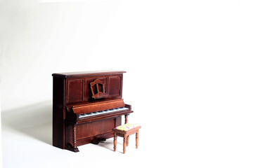 piano and a backless stool on pink background