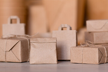 small paper bag on the background of paper boxes and bags