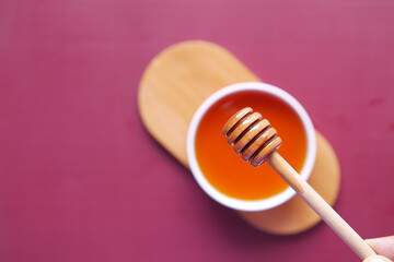 close up of fresh honey with spoon on table 