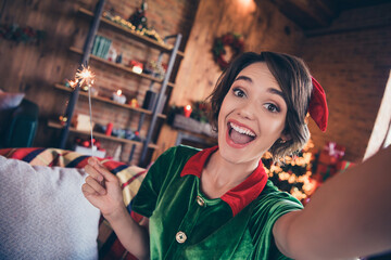 Photo of crazy excited lady hold bengal fire make selfie open mouth wear elf costume in decorated...