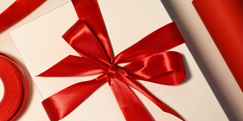 closeup of a white giftbox with red bow.winter holidays concept