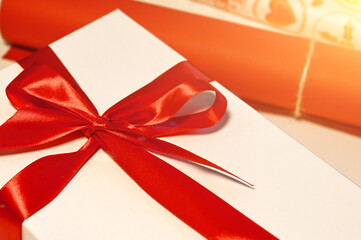 Gift with red bow and wrapping paper near.Christmas concept
