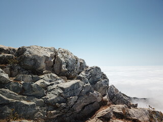 Fototapeta na wymiar Rocky mountain above cloud sea