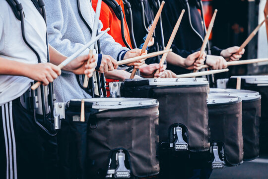 section of a marching band drum line warming up before rehearsal