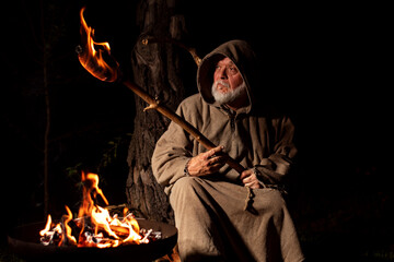 Angry poor farmer in the middle ages with a torch