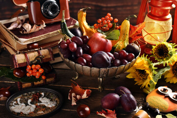 Autumn still life with seasonal fruits and decors in rustic style