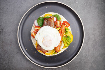 kebab with bacon and fried egg, tomato, spinach, avocado, pickled peppers
and sauce delicious on the plate