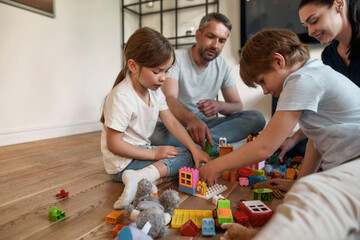 Kids have fun play toys with loving parents
