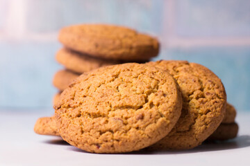 Healthy oatmeal cookies on a blue brick background