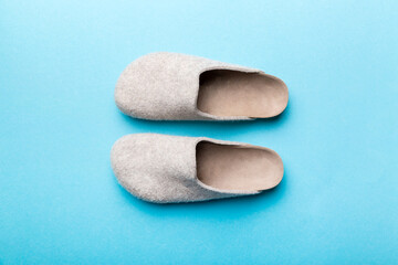 Warm winter women woolen slippers on colored background. Copy space for text