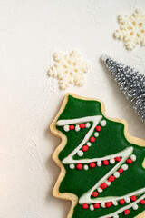 Fototapeta premium Decorated Christmas gingerbread cookies with decorations on white table background.