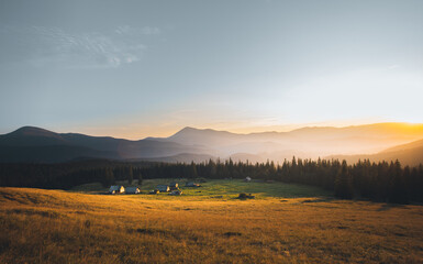 Plakat panorama of sunset in the mountains. sunbeams. rest on mountain tops. rays of the sun
