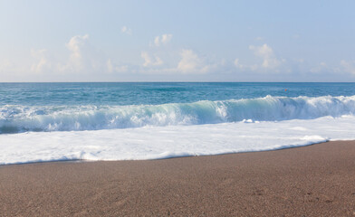 Waves on the beach. Sand and blue water. Sicily, Italy.