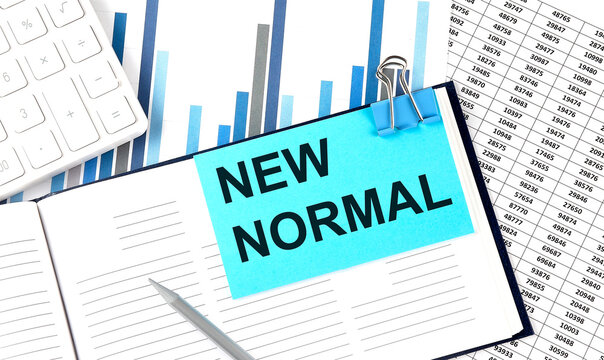 NEW NORMAL text on blue sticker on the chart background near calculator