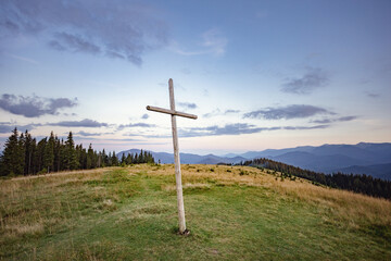 big wooden cross on top of the mountain. mountain landscape