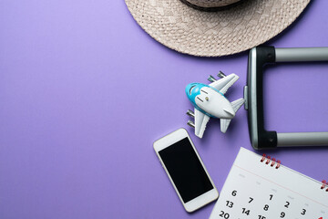 concept of travel vacation trip and long summer weekend planning on purple table background