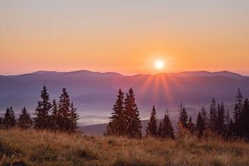 Naklejka na ściany i meble sunbeams. sunrise in the mountains. incredible mountain landscape