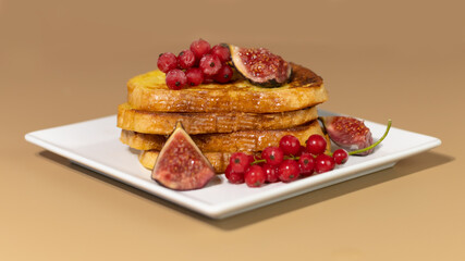 Traditional French toast with figs and red currants. Fried bread soaked in a mixture of milk, eggs and sugar.