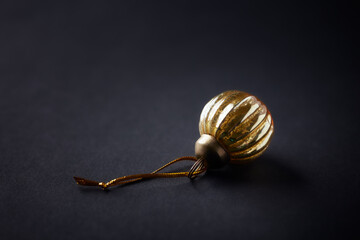 Christmas ornament on dark paper background. Close up. Copy space.	
