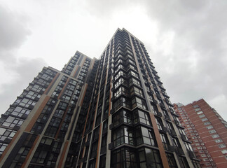 Fototapeta premium High modern buildings over the dark rainy sky background