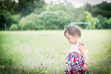 Close up little girl Asian happiness running on lawn, 1-2 year old.