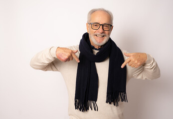 Grey haired senior man wearing winter clothing standing over white background looking confident...