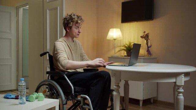 A disabled man is spreading his arm in different sides 